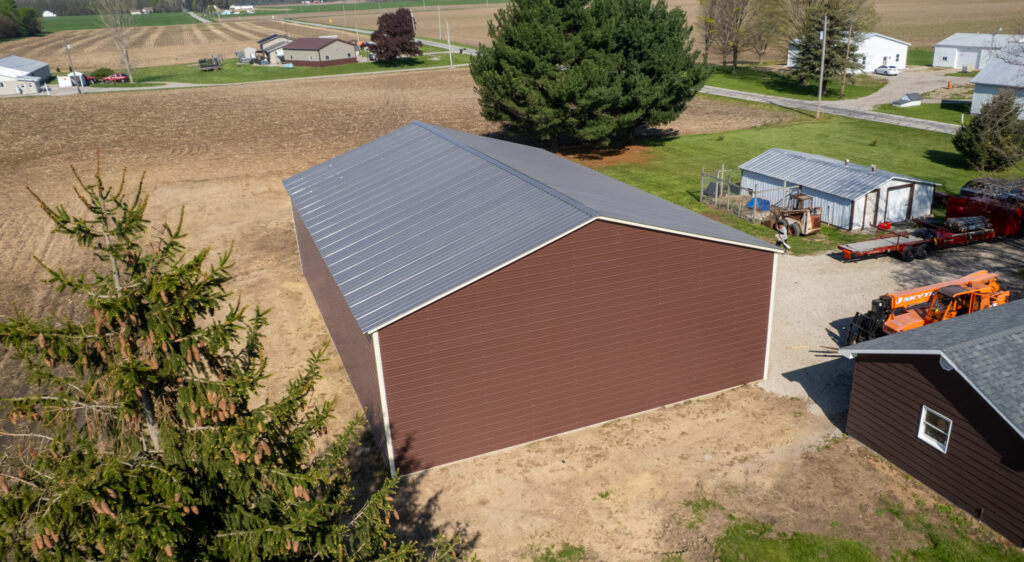 Red barn-style metal building on a rural property