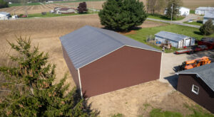 Red barn-style metal building on a rural property